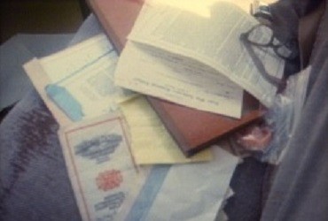 Several important documents are laid out on the back seat of a car