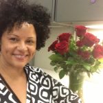 Alicia Griffin, smiling with roses