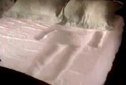 A mattress with an imprint of a human body.