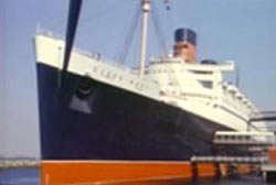 A colored photo of the Queen Mary while docked at a pier.