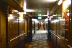 One of the ship's hallway. Red and gold carpet, wodd panelling on the walls.