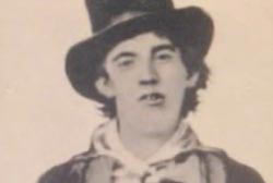 Headshot of Billy the Kid, age 19, wearing a hat.