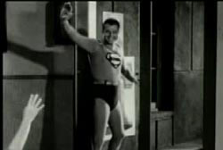 George Reeves in the Superman costume waving at fans.