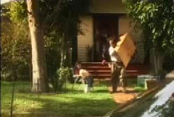 A family is moving their belongings out of a surburban house.