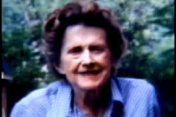 An elderly woman, Annie Laurie Hearin, with short curly hair and a blue shirt.