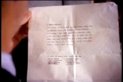 A typed letter, the kidnapper's note is being held up, though it is ineligible.