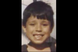 A young boy, Rene Perez, smiling. 