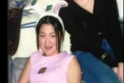 Cindy Song wearing a pink shirt and rabbit ears. 
