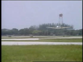 A small plane making a landing in a small airfield.