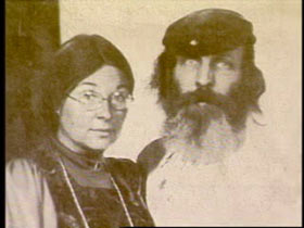 Hugh poses with his wife, Dian. She has straight dark hair and wire rim glasses.