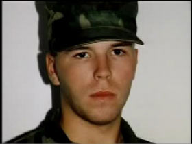 A young soldier in a green camo hat, Justin Burgwinkel.