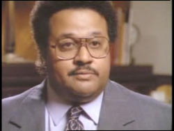 A middle age african american with short hair and glasses, Geoffrey Harding.