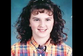 A caucasian teenage girl with black curly hair with bangs, Lauria Bible.