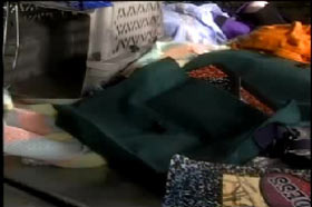 A closer look at the personal belongings in the back seat, including shoes, clothes and books.