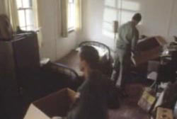 Two men packing up a small bedroom. 