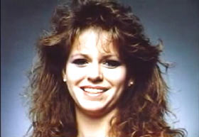 A young woman, Tara Breckenridge, with long brown hair.