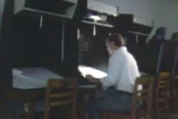 A man sitting at a work station in a library.