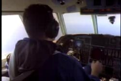 A pilot in the cockpit of a small plane.