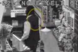A still from the security camera of the robber that shows he may have had a hump on their shoulders.