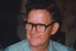 A middle aged caucasian man, Dexter Stefonek, with short curly hair and large glasses.