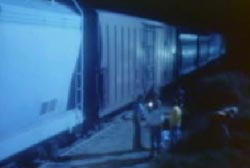 Investigators searching for a green tarp next to the train