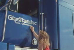 A woman Knocking on the driver side door of a semi truck