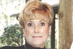 Smiling Joan Jefferies in a turtle neck with short blonde hair 