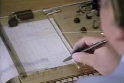 A man using a pen to analyse a lie detector test