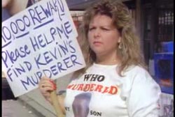 Kevin's mom holding a sign that reads '10,000 reward please help me find kevins murderer'