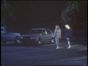 Two women walking towards a car in a parking lot