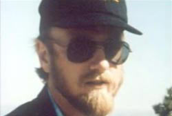 Mark Groezinger with a hat, beard, and sunglasses