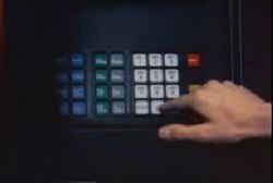 A hand clicking buttons on an ATM