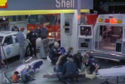 Large group of Paramedics kneeling around Hunter attempting to resuscitate