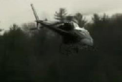 A helicopter hovering over a forest