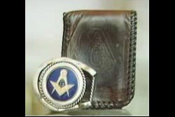 A wallet and belt buckle with freemason insignias