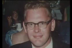 Smiling Ralph Probst with glasses in a suit