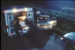 Police and EMT wheeling the covered body of Rhonda Hinson into the back of an ambulance