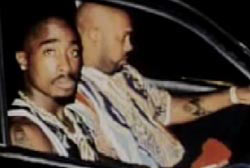 Tupac and Suge Knight in the front seat of a car