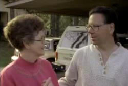 Bruce talking to a member of the Johnson family outside their home