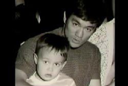 Bruce Lee with son Brandon Lee sitting on his lap