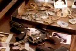 Photos, police badges, and revolvers in a drawer