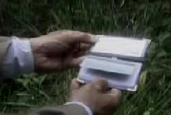 An investigator holding Joyce's open wallet