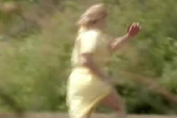 Margo in yellow clothes running into the woods