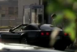 A black corvette picking up Nova at a payphone