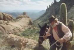 Jacob Waltz leading a mule through a ridge in the mountain
