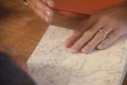 A hand over a map detailing where to find the gold ore