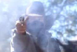 A gang member firing off a revolver leaving a cloud of gunsmoke