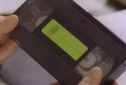 A person holding a VHS tape