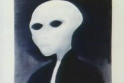 A drawing of humanoid figure with larg head, and big black almond shaped eyes. An 'Alien'