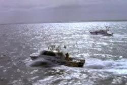 Two search boats driving slowly through the ocean